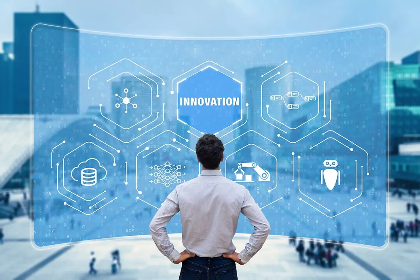 Man looks at a large screen displaying complex graphics